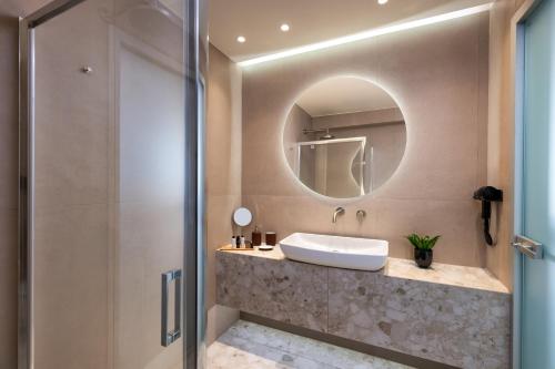 a bathroom with a sink and a mirror at Pelagus City - Luxury Suite II in Thessaloniki