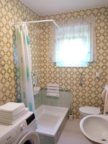 a bathroom with a shower and a toilet and a sink at Apartment Tea 1 in Okrug Donji