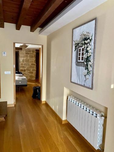 a living room with a fireplace and a painting on the wall at Casa Moneo in Briones