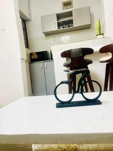a bike statue sitting on a counter in a kitchen at Joel's Residence in Lagos