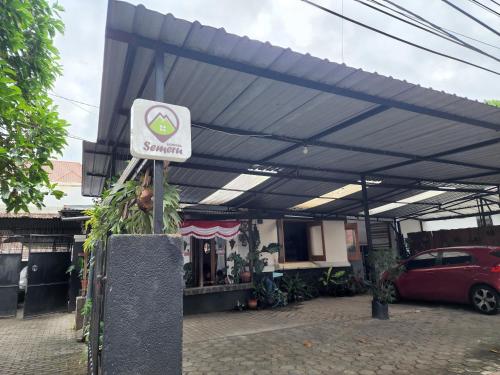 awning over a parking lot in front of a store at SEMERU HOSTEL MALANG in Malang