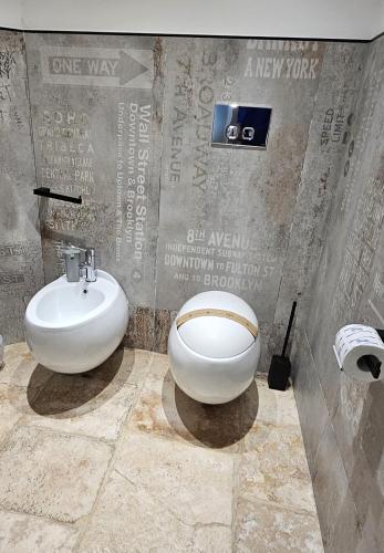 a bathroom with a sink and a toilet in it at Binario1 Rooms in Barletta