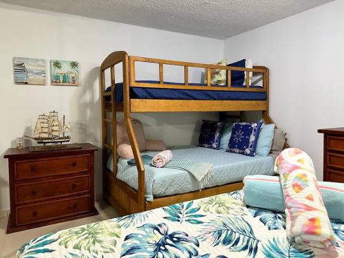 a bedroom with two bunk beds and a bed at Marina View Condo 2 Bed / 2 Bath Sleeps 7 in Fajardo