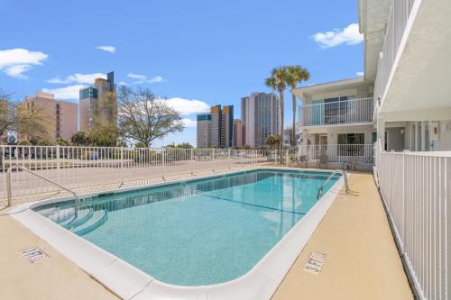 a swimming pool in a building with a city skyline at Fin's Inn in Myrtle Beach