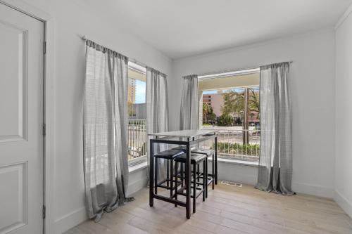 a dining room with a table and two windows at Fin's Inn in Myrtle Beach