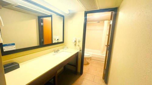 a bathroom with a sink and a toilet and a mirror at Comfort Inn Salt Lake City Downtown in Salt Lake City