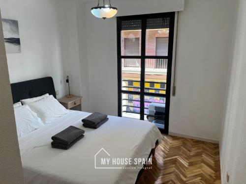 a bedroom with a bed with two towels on it at MyHouseSpain - Maravilloso apartamento renovado in Madrid