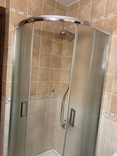 a shower with a glass door in a bathroom at Nereid Skyros House in Skiros