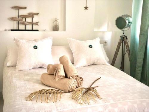 a bed with two towels and two pillows on it at Luxury Bahia Sea Views By Deihu Experiences in Los Cristianos