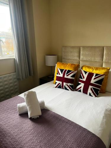 a bedroom with a large bed with british pillows at 43A ground floor apartment in London
