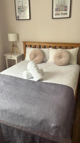 a large bed with two pillows on top of it at 43A ground floor apartment in London