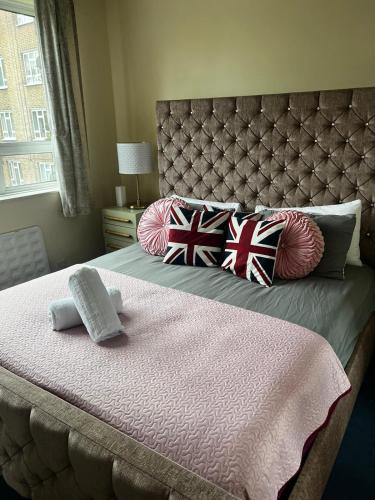 a bedroom with a large bed with pillows on it at 43A ground floor apartment in London