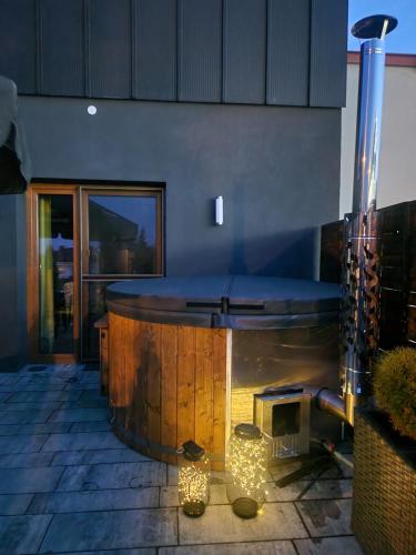 a hot tub in the middle of a patio at Domek 104 in Zamość