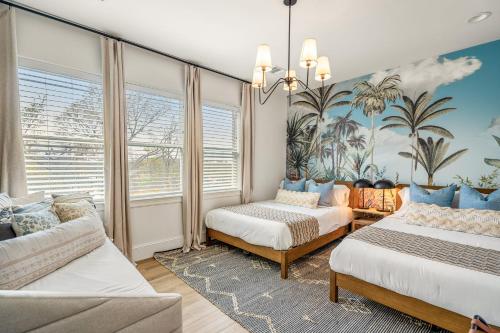 a bedroom with two beds and a couch at The Green Haus: Luxxe Cabana Rooftop Retreat in Houston