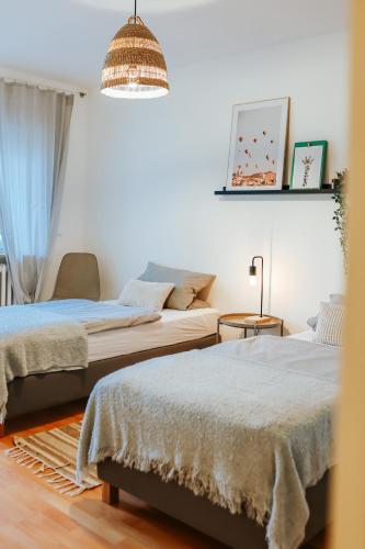 a bedroom with two beds and a couch at namastay! Stilvoll Wohnen im Herzen von Mannheim in Mannheim