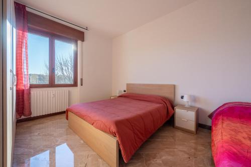 a bedroom with a bed and a large window at Rainbow House. Rho Fiera Milano in Rho
