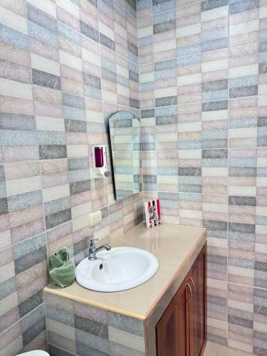 a bathroom with a sink and a mirror at Hotel El Chaman in Uvita