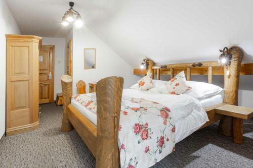 a bedroom with two beds and a staircase at Penzion Koliba in Tatranská Kotlina