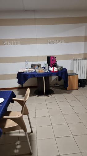 a table and a chair in a room with a house at B&B White House in Melfi