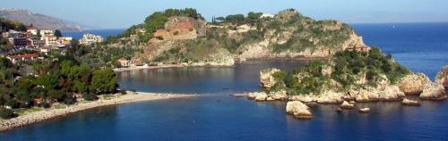 an island in the middle of a body of water at Holiday Home Gionny & Mary in Taormina