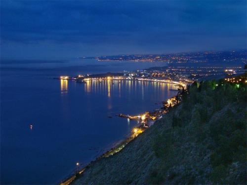 a view of a large body of water at night at Holiday Home Gionny & Mary in Taormina