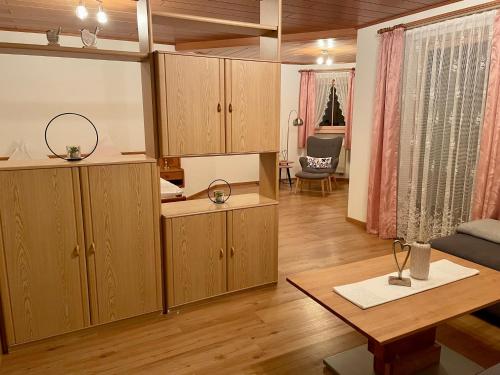 ein Wohnzimmer mit Holzschränken und einem Tisch in der Unterkunft Ferienwohnungen Pichler in Hohenau