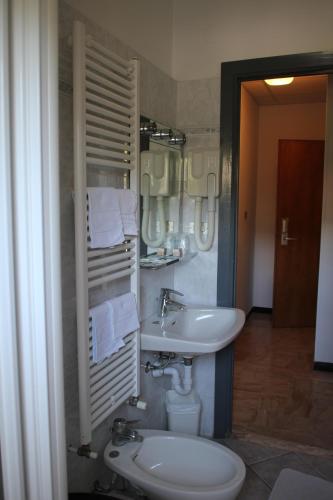 a bathroom with a sink and a toilet at Hotel Mediterranée in Spotorno