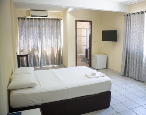 Postel nebo postele na pokoji v ubytování Smart Cataratas Hotel