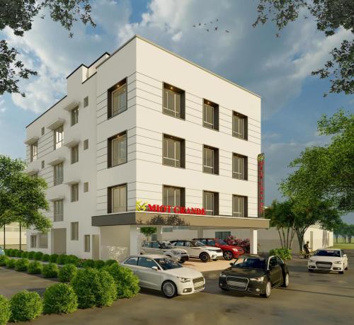 a rendering of a white building with cars parked in a parking lot at Miot Grande in Chennai
