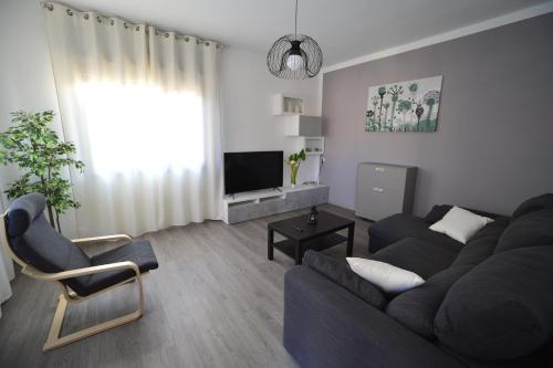 a living room with a couch and a tv at Casa Laita in Sarego