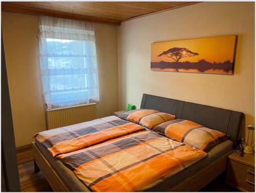a bedroom with a large bed with a window at Gemütliche Wohnung/ cozy apartment Niklasdorf in Niklasdorf