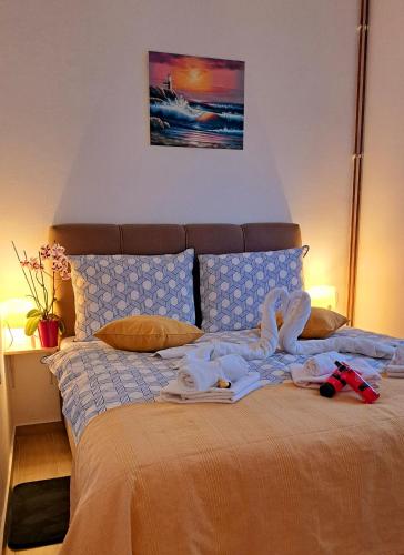 a bed with some clothes on top of it at Apartman Leon in Rijeka