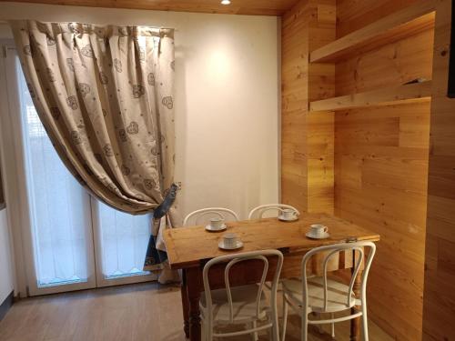 a dining room with a wooden table and chairs at CHALET GIOVANNI in Aprica