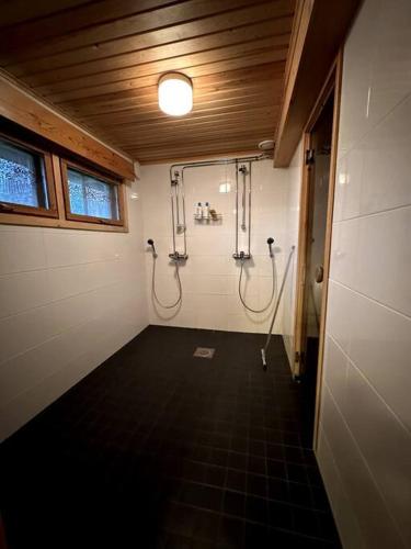 a walk in shower in a bathroom with twooses at Saajopolku 4 in Saariselka