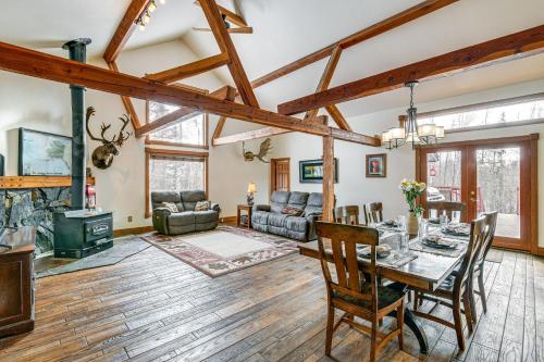 a living room with a table and a fireplace at Beautiful Wasilla Home Rental with Deck and Gas Grill! in Wasilla