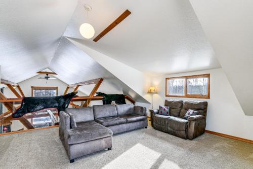 a living room with a couch and a chair at Beautiful Wasilla Home Rental with Deck and Gas Grill! in Wasilla