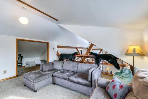 a living room with a couch and a staircase at Beautiful Wasilla Home Rental with Deck and Gas Grill! in Wasilla