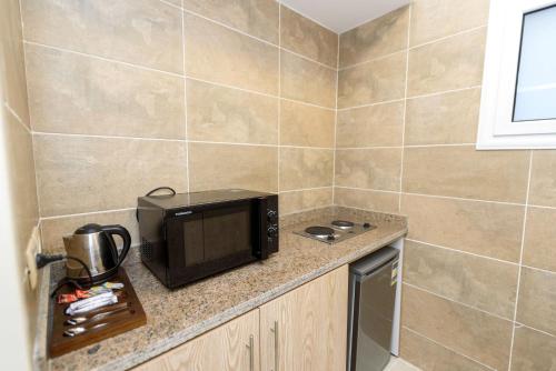 a microwave sitting on a counter in a kitchen at Marom Port Said Resort & Beach in Port Said