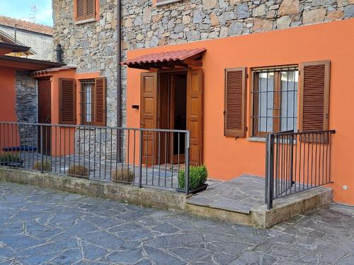 an orange house with a gate in front of it at Mila Apart in Ghevio