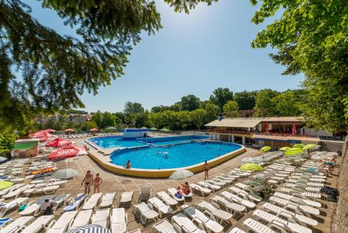 a pool at a resort with lounge chairs at Hotel Padis in Baile Felix