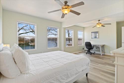 a bedroom with a white bed and a ceiling fan at Oak Haven Retreat in Sunrise Beach