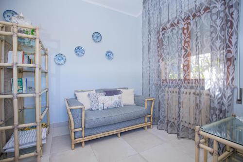 a living room with a chair and a window at Affitti Brevi Toscana - Villa Charme Simple in Fonteblanda