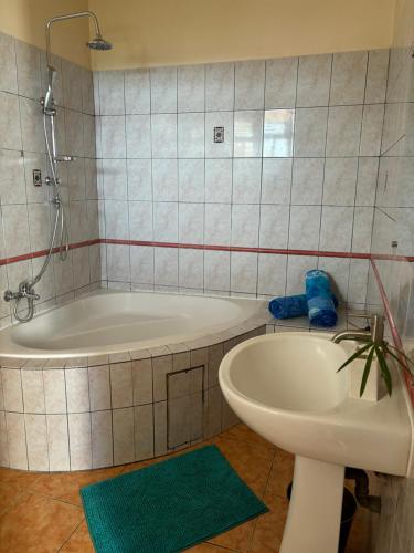 y baño con bañera, aseo y lavamanos. en Villa Elise Jolie Maison , Piscine, WiFi, pour 7 personnes en Ducos