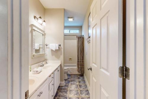 a bathroom with a sink and a toilet and a mirror at Grove By The Sea: Passin' Thru in Santa Rosa Beach