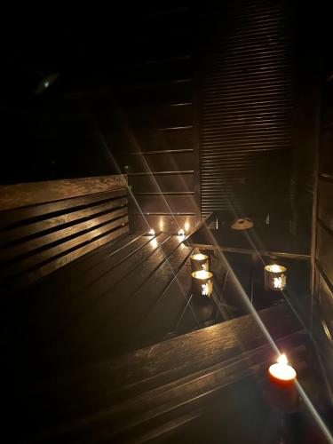 a set of stairs with candles in the dark at Rubin Apartment in Kajaani