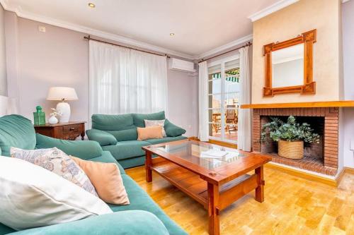 a living room with a couch and a table at Beach Duplex with Sea views in Málaga