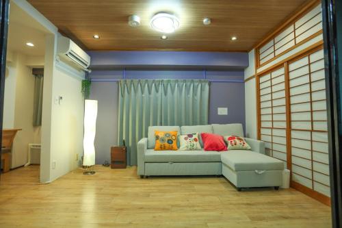 a living room with a couch with pillows on it at Fushimi Yokkusu Building 10F - Vacation STAY 16301 in Nagoya
