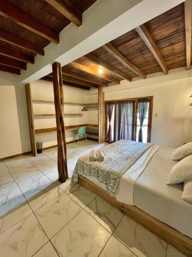 a bedroom with a large bed in a room at Casa Peregrina in Ayampe