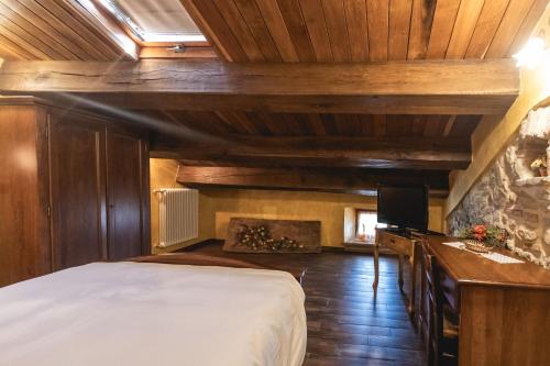 a bedroom with a bed and a fireplace at La Locanda dell'Ambra in Talamello