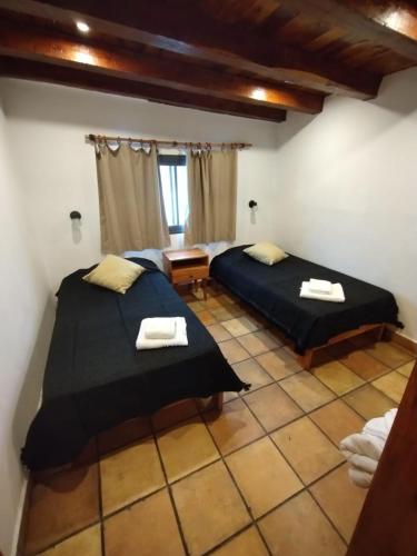a room with two beds in a room at Mulelle cabañas in Ciudad Lujan de Cuyo